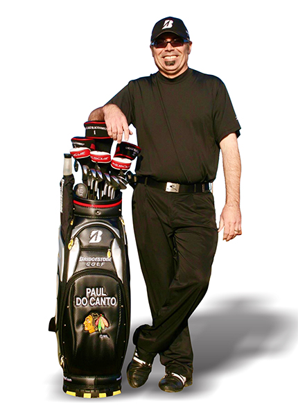 Paul standing with golf clubs